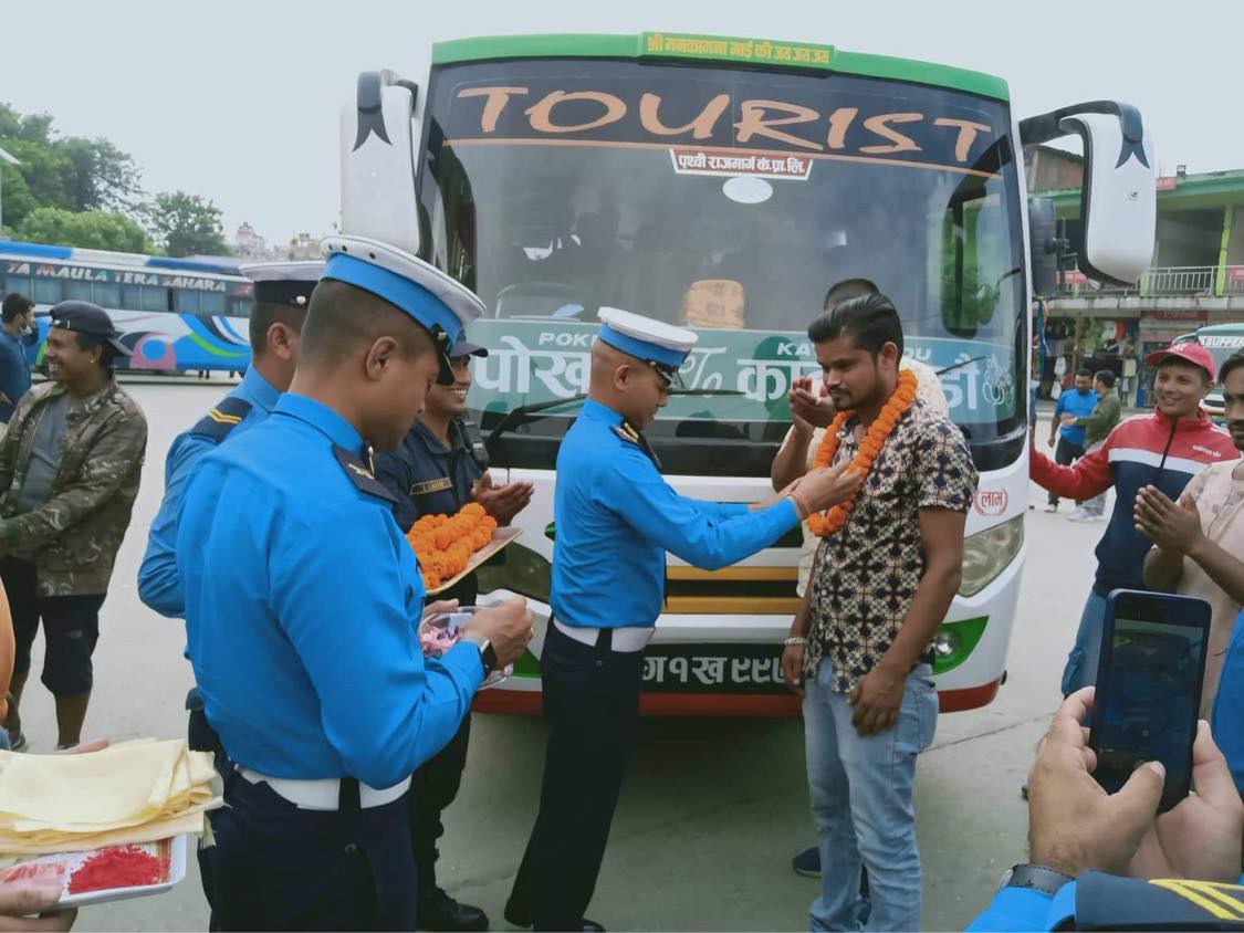 ट्राफिक प्रहरीद्वारा सुरक्षित यात्राको कामना गर्दै चालकलाई फूलमाला